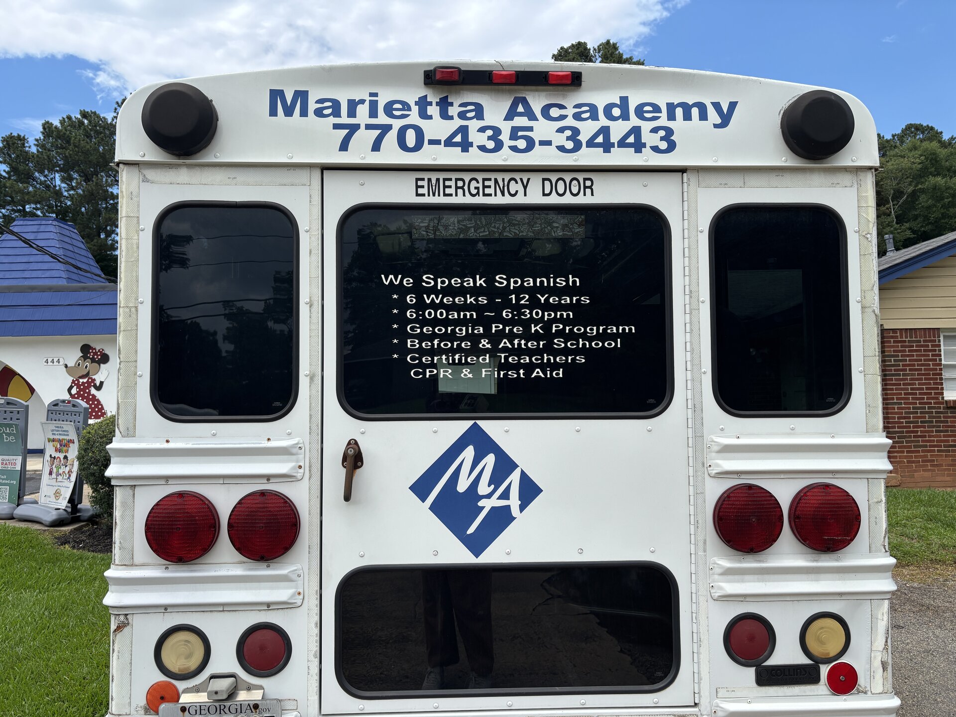 Marietta Academy school bus with We Speak Spanish, Georgia Pre-K, Certified Teachers at Marietta Academy