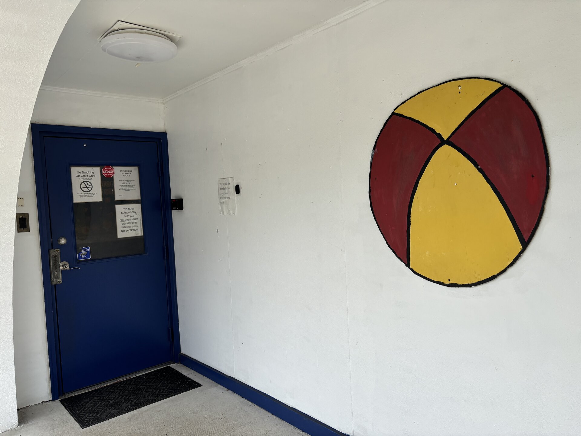 Front entrance of Marietta Academy with secured entry and beach-ball mural