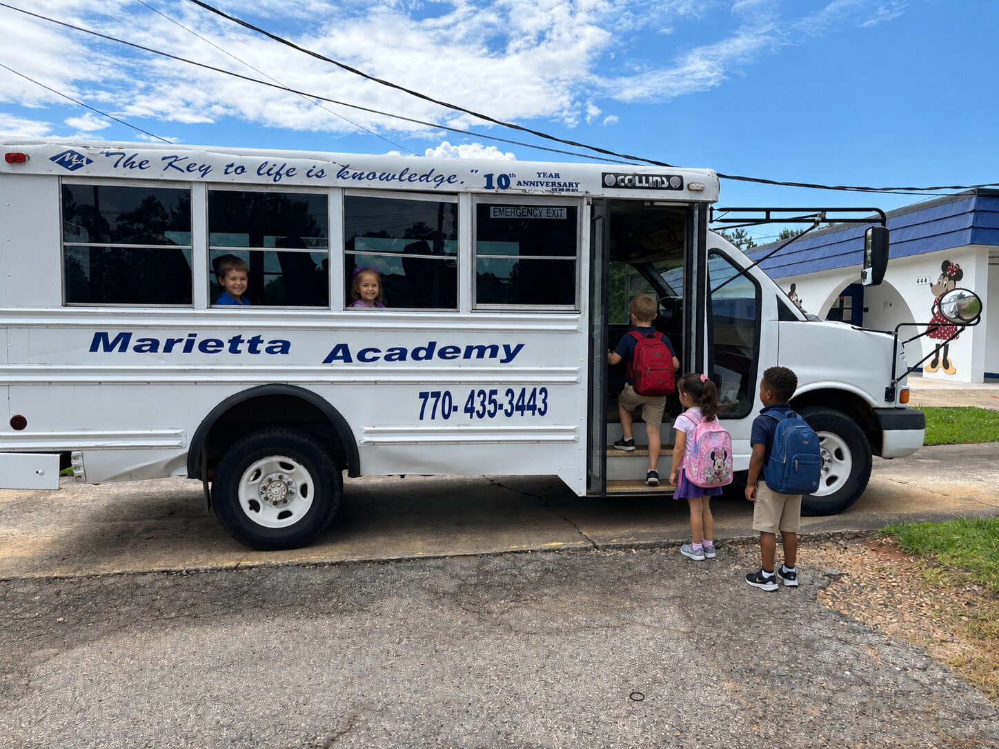 Pre-K students boarding the Marietta Academy school bus